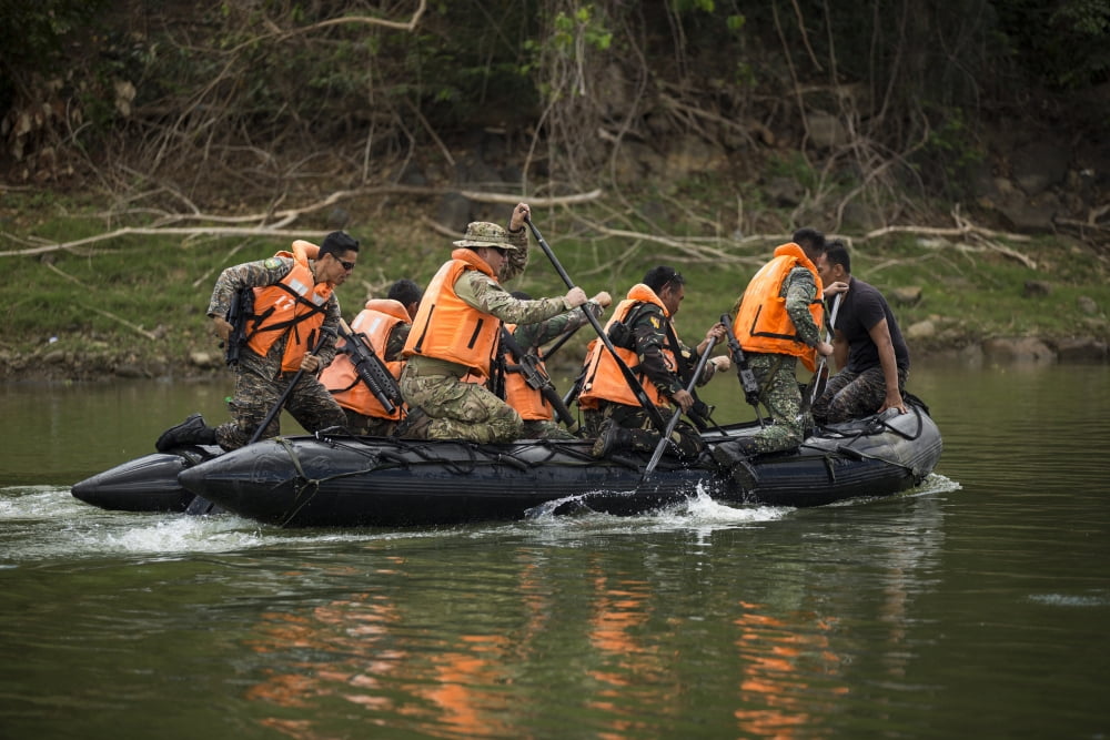Philippine and US special operations forces soldiers paddle a river Canvas Art - Stocktrek Images (34 x 23)