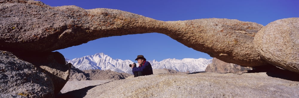 Photographer Joe Sohm with panoramic camera frames shot of Mount Whitney through Alabama Hills Arch in Alabama Hills near Lone Pine California Canvas Art - Panoramic Images (27 x 9)