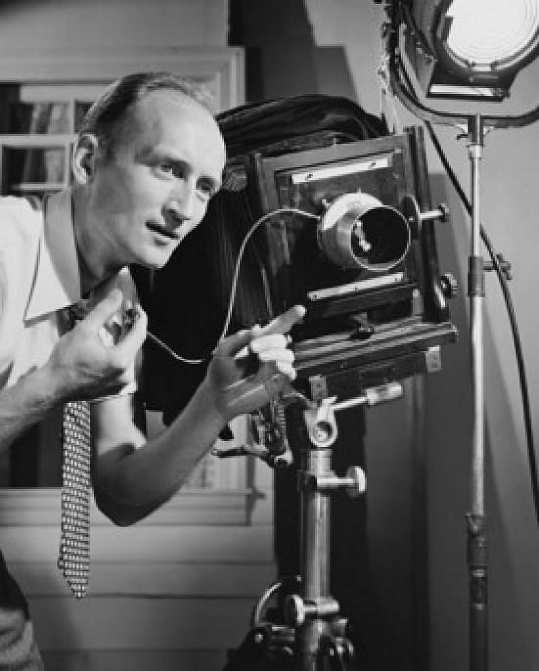 Photographer adjusting the focus of a camera Canvas Art - (18 x 24)
