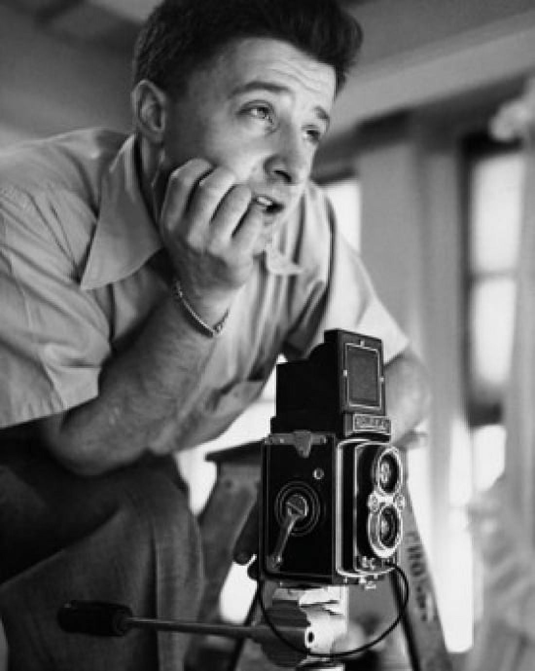 Photographer near a camera with his hand on his chin Canvas Art - (24 x 36)