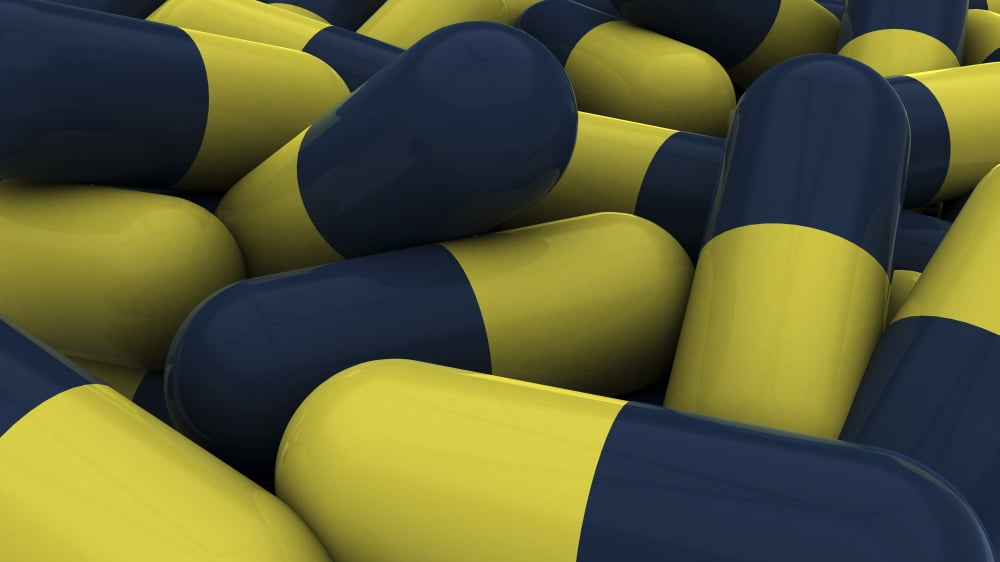 Pile of blue and yellow medication capsules Canvas Art - Stocktrek Images (38 x 22)