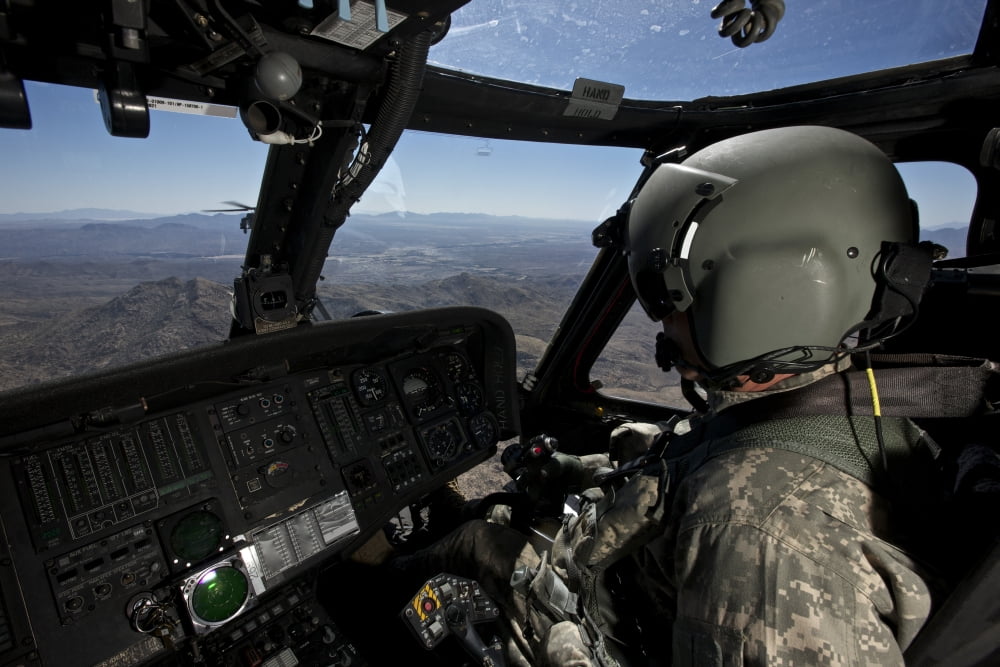 Pilot operating the cockpit of a UH-60 Black Hawk helicopter Canvas Art - Terry MooreStocktrek Images (35 x 23)