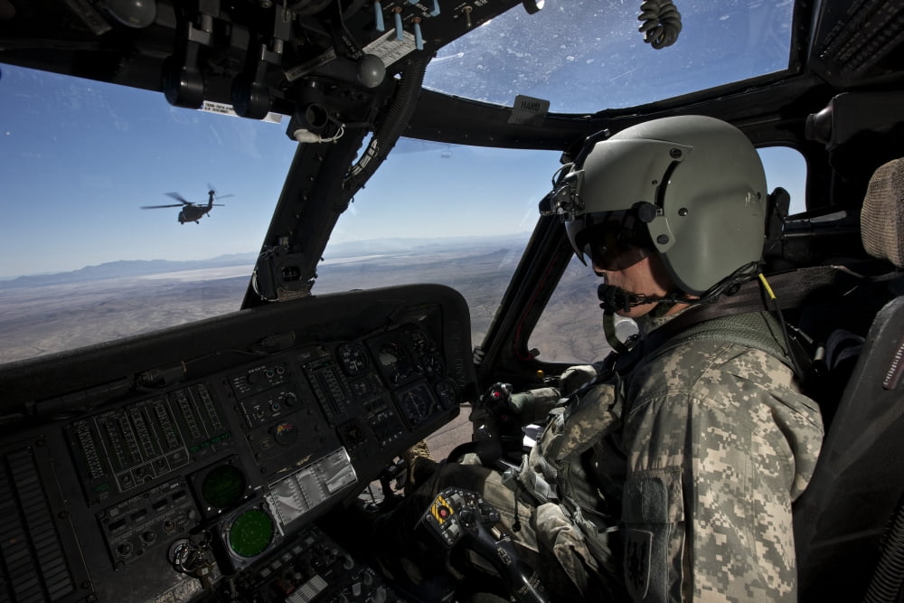 Pilot operating the cockpit of a UH-60 Black Hawk helicopter Canvas Art - Terry MooreStocktrek Images (35 x 23)