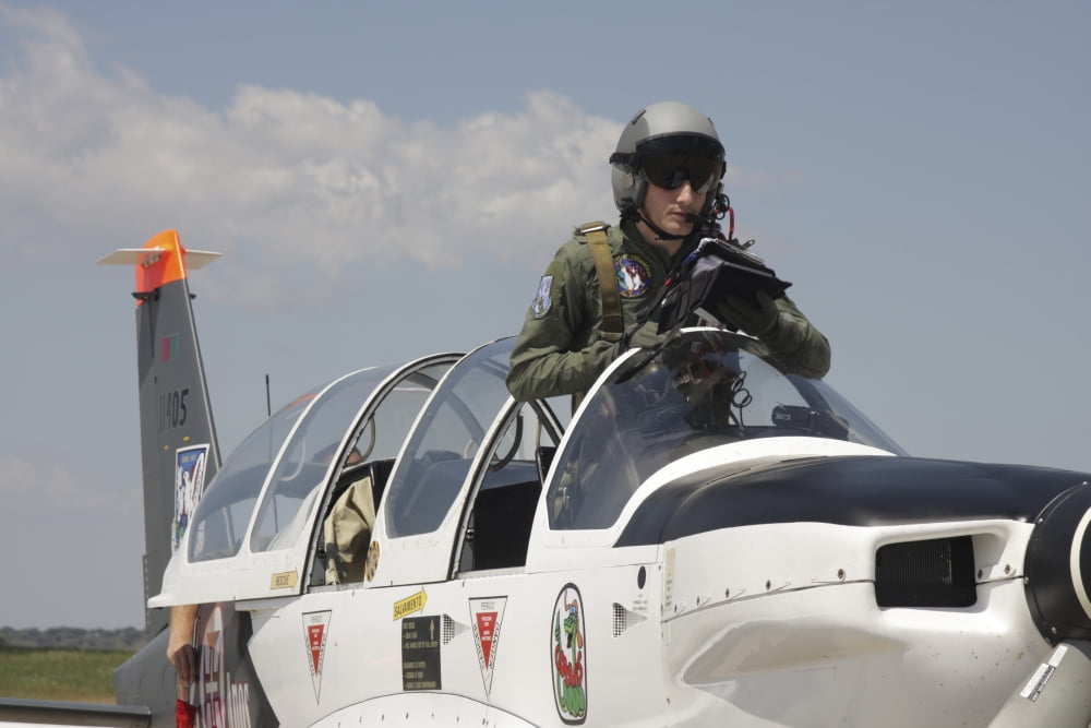 Pilot standing in a Socata TB-30 Epsilon trainer aircraft Canvas Art - Timm ZiegenthalerStocktrek Images (35 x 23)