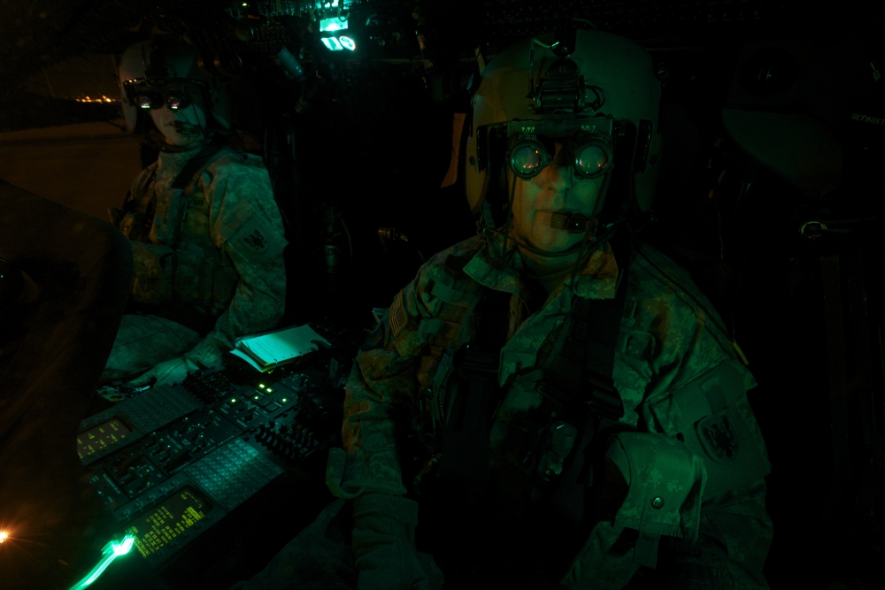 Pilots equipped with night vision goggles in the cockpit of a UH-60 Black Hawk Canvas Art - Terry MooreStocktrek Images (35 x 23)
