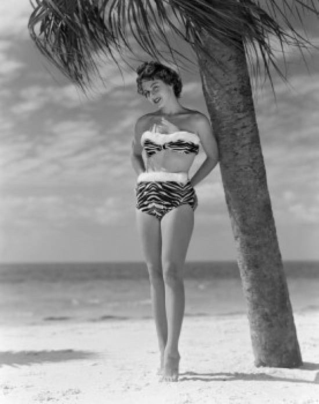 Pin-up girl standing under palm tree wearing bikini Canvas Art - (18 x 24)