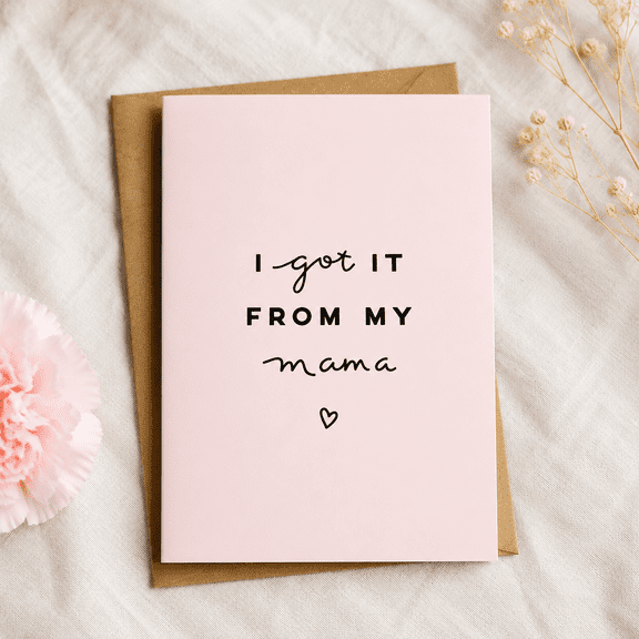Pink card "I got it from my mama", features bold and cursive font, perfect for Mother's Day or celebrating moms on various occasions.