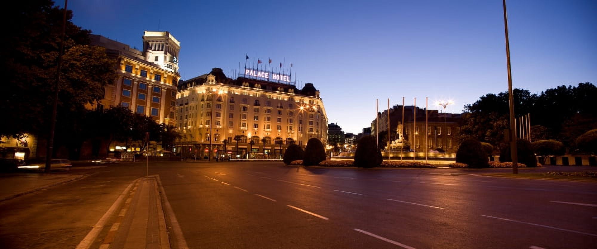 Plaza De Neptuno and Palace Hotel at dusk Madrid Spain Canvas Art - Panoramic Images (27 x 9)