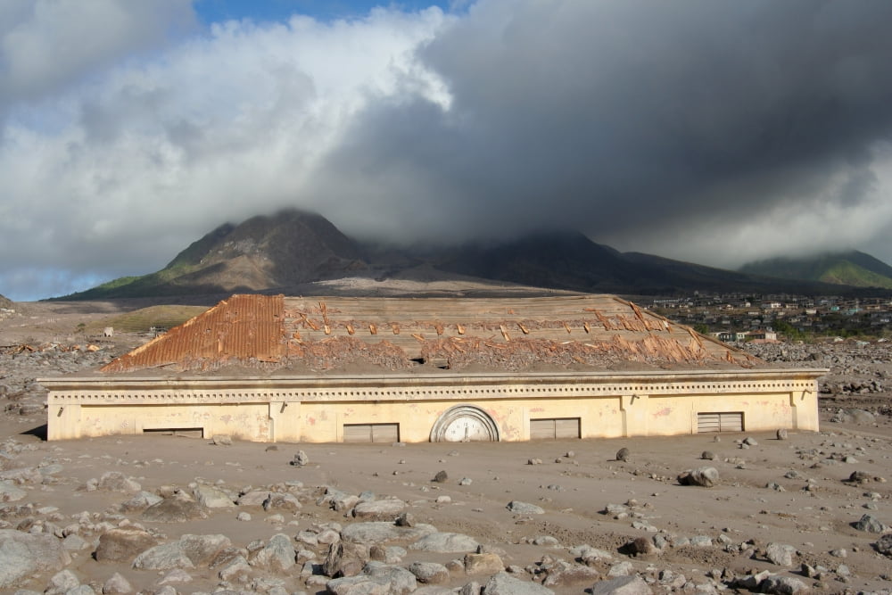 Plymouth Courthouse buried in lahar deposits from Soufriere Hills volcano Montserrat Caribbean Canvas Art - Richard RoscoeStocktrek Images (17 x 12)