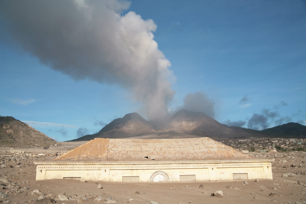 Plymouth Courthouse buried in lahar deposits from Soufriere Hills volcano Montserrat Caribbean Canvas Art - Richard RoscoeStocktrek Images (18 x 12)