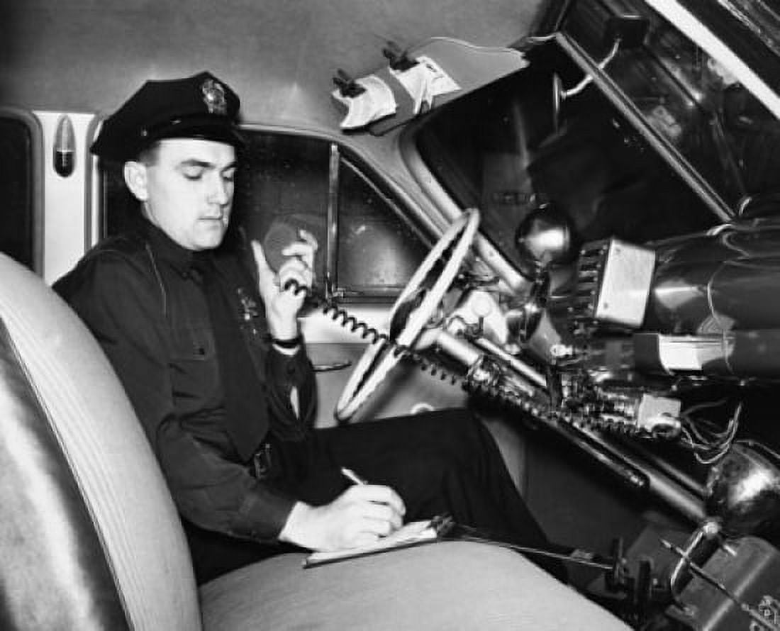 Police officer sitting in a police car and talking on a CB radio Canvas Art - (24 x 36)