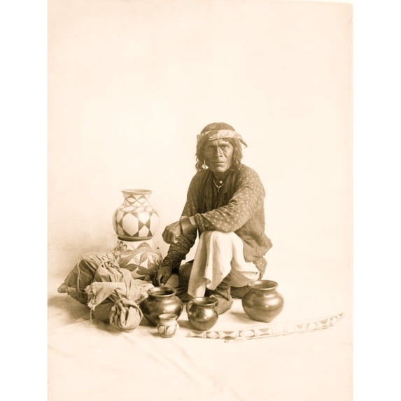 Portrait of Indian man seated, posing with pottery, New Mexico. Poster Print (18 x 24)