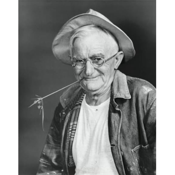 Portrait of a Senior Man Smiling with a Twig in His Mouth Poster Print - 18 x 24 in.