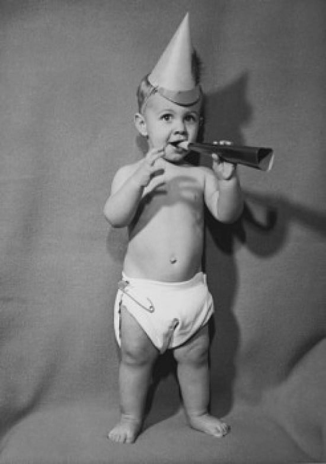 Portrait of a baby boy blowing a noisemaker Canvas Art - (18 x 24)