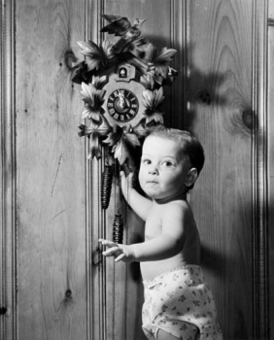 Portrait of a baby boy standing near a cuckoo clock Canvas Art - (18 x 24)