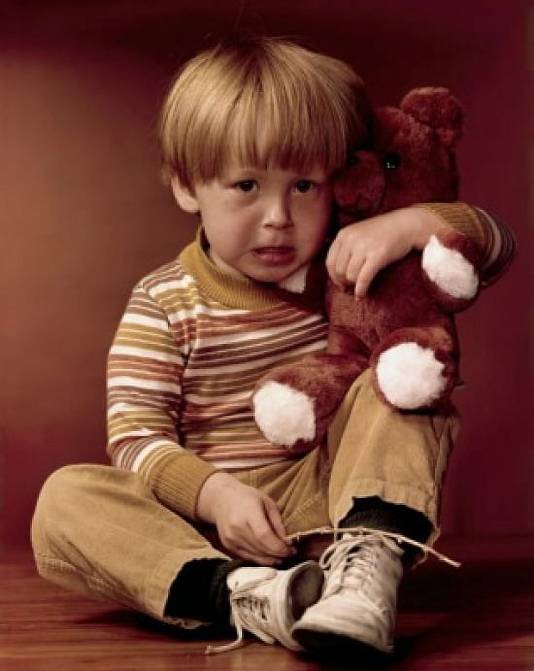 Portrait of a boy holding a teddy bear and looking displeased Canvas Art - (18 x 24)