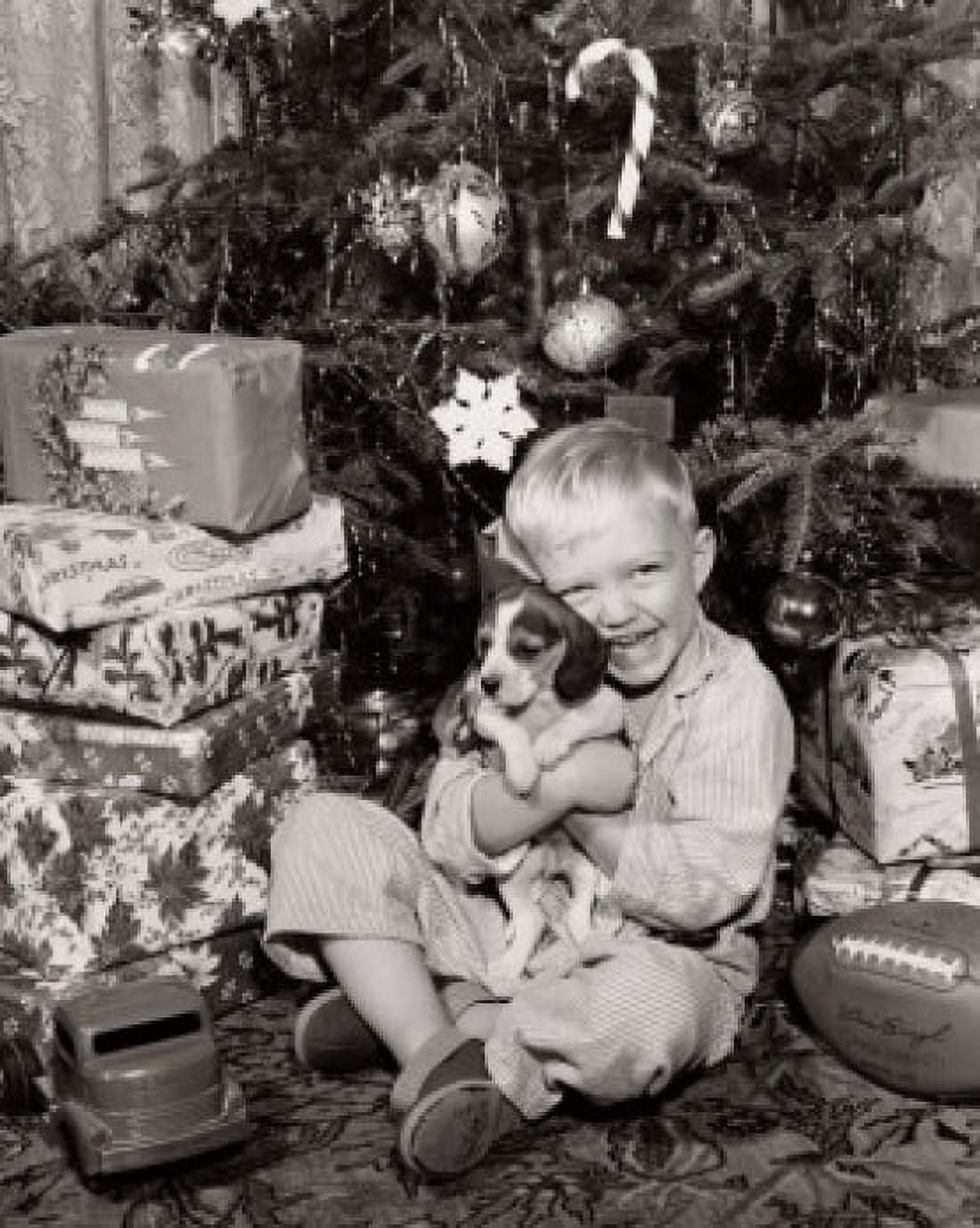 Portrait of a boy sitting near Christmas presents and hugging his puppy Canvas Art - (18 x 24)
