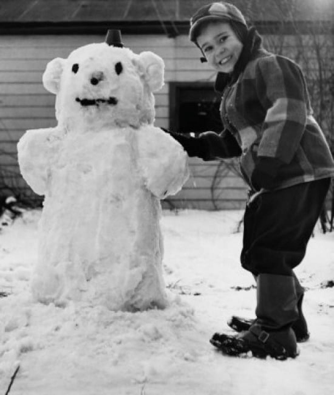 Portrait of a boy standing near a snowman Canvas Art - (24 x 36)
