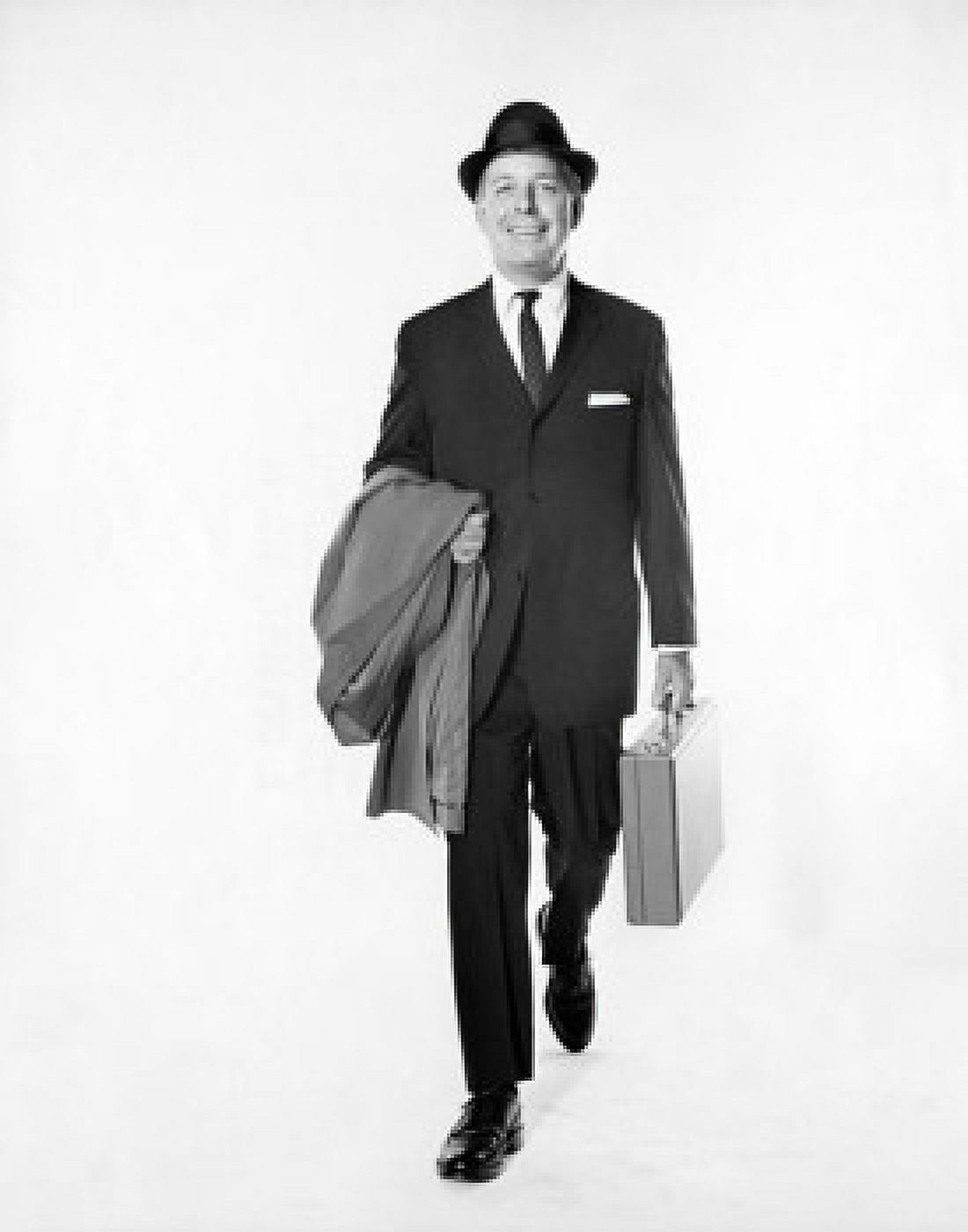 Portrait of a businessman carrying a briefcase and an overcoat Canvas Art - (24 x 36)