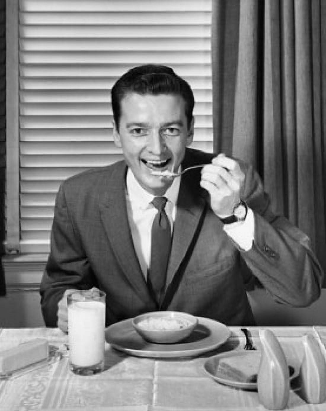 Portrait of a businessman eating breakfast Canvas Art - (18 x 24)