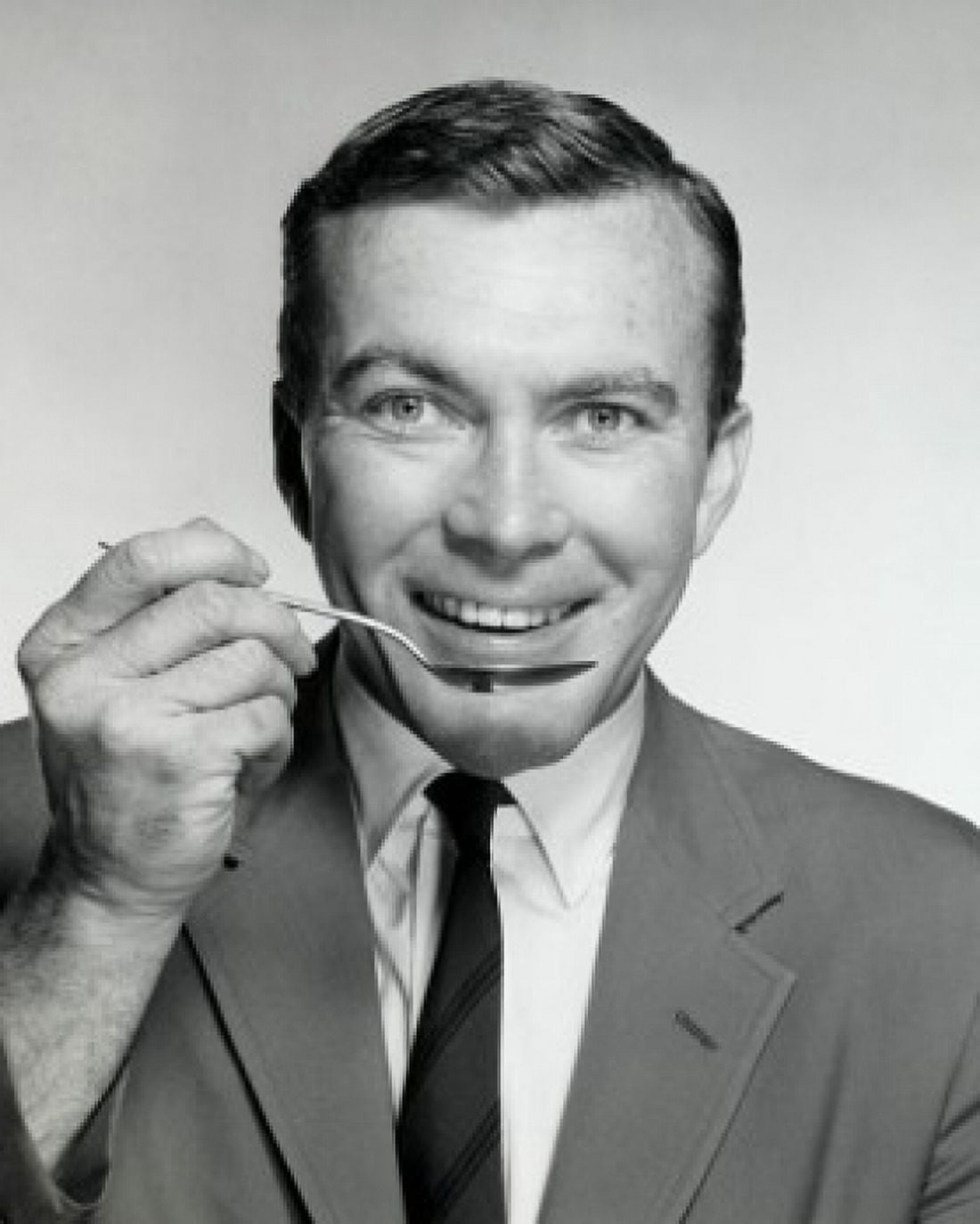 Portrait of a businessman eating with a spoon Canvas Art - (18 x 24)