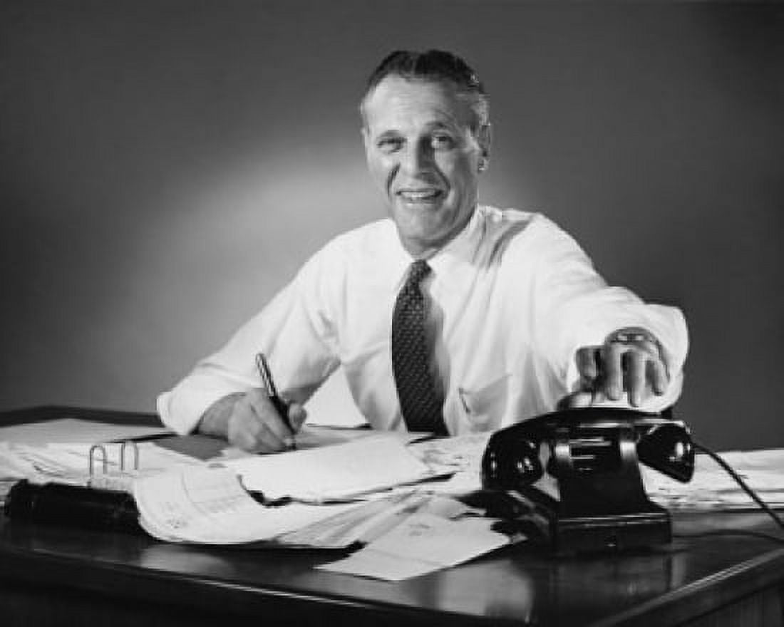Portrait of a businessman reaching for a telephone Canvas Art - (24 x 36)