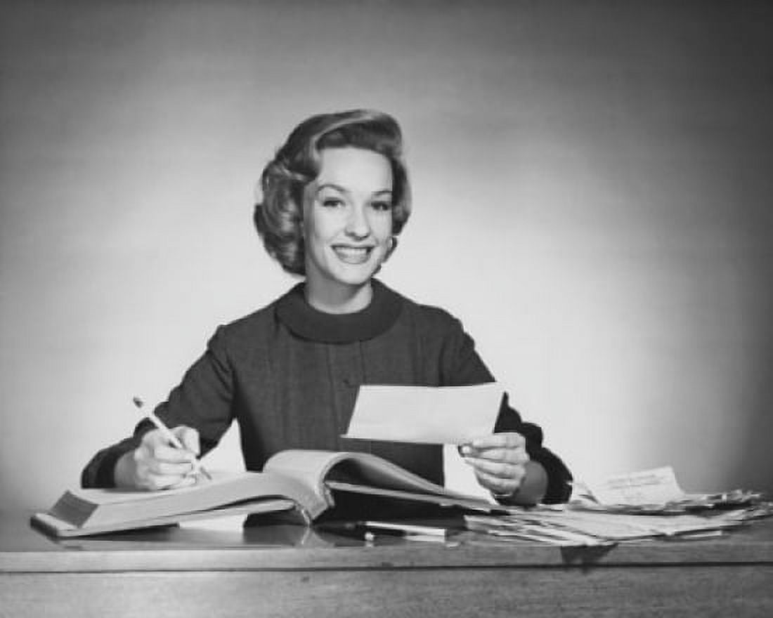 Portrait of a businesswoman writing in an accounting ledger Canvas Art - (24 x 36)