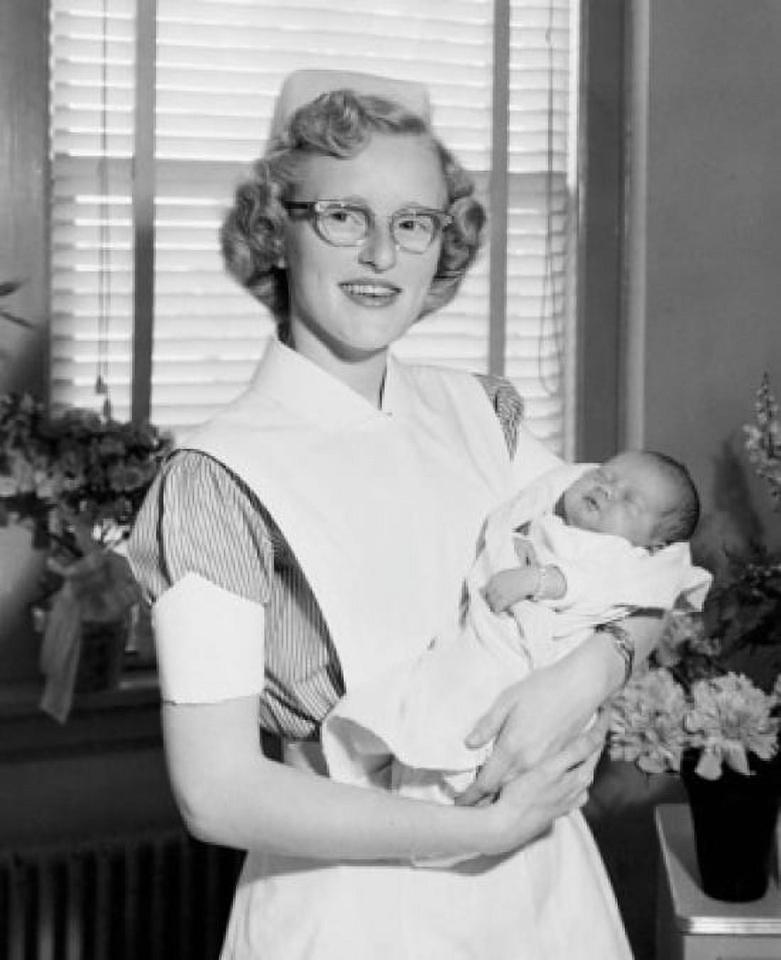 Portrait of a female nurse carrying a newborn baby boy Canvas Art - (18 x 24)