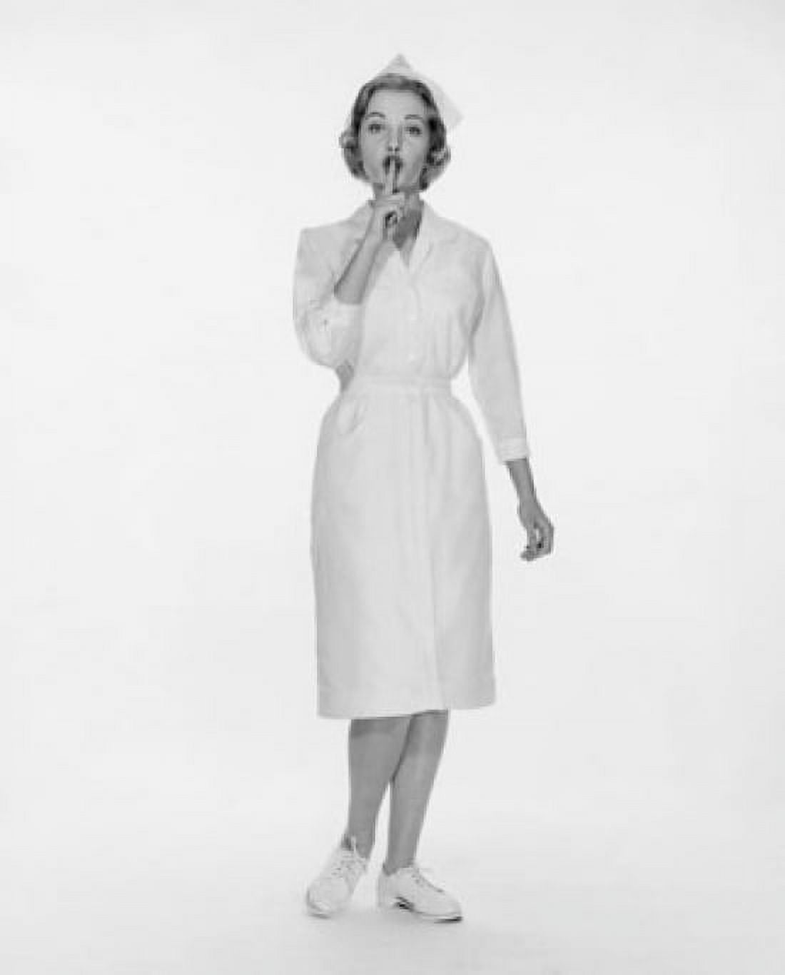 Portrait of a female nurse standing with her finger on her lips Canvas Art - (18 x 24)