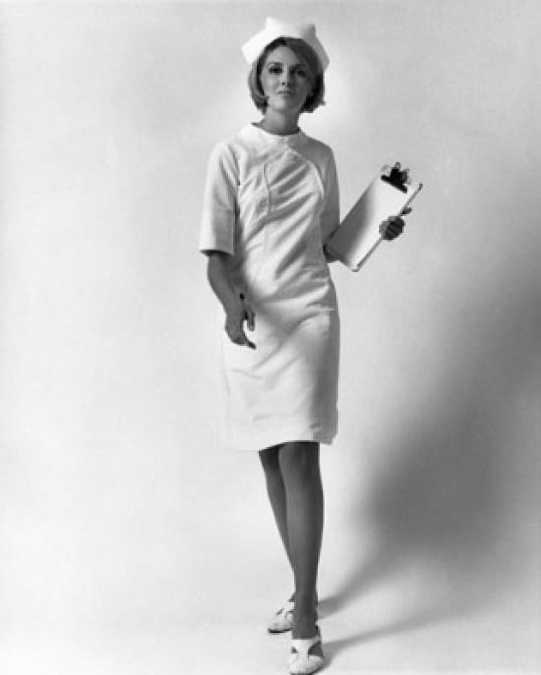 Portrait of a female nurse walking and holding a clipboard Canvas Art - (24 x 36)