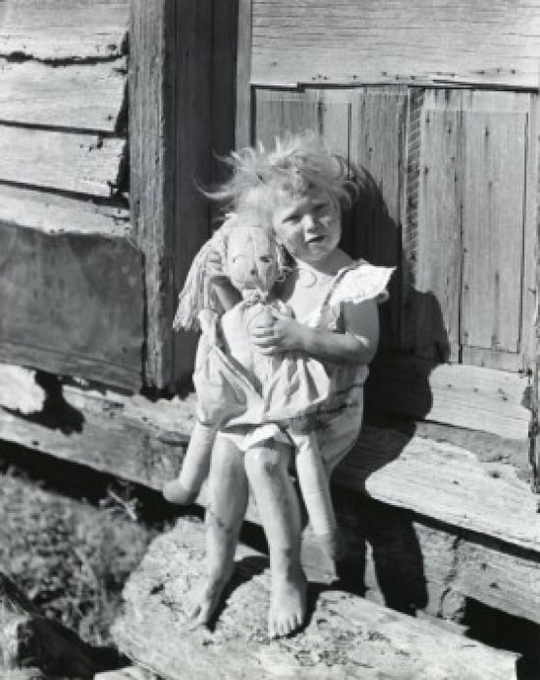 Portrait of a girl holding a doll sitting on the doorstep of a house Canvas Art - (18 x 24)