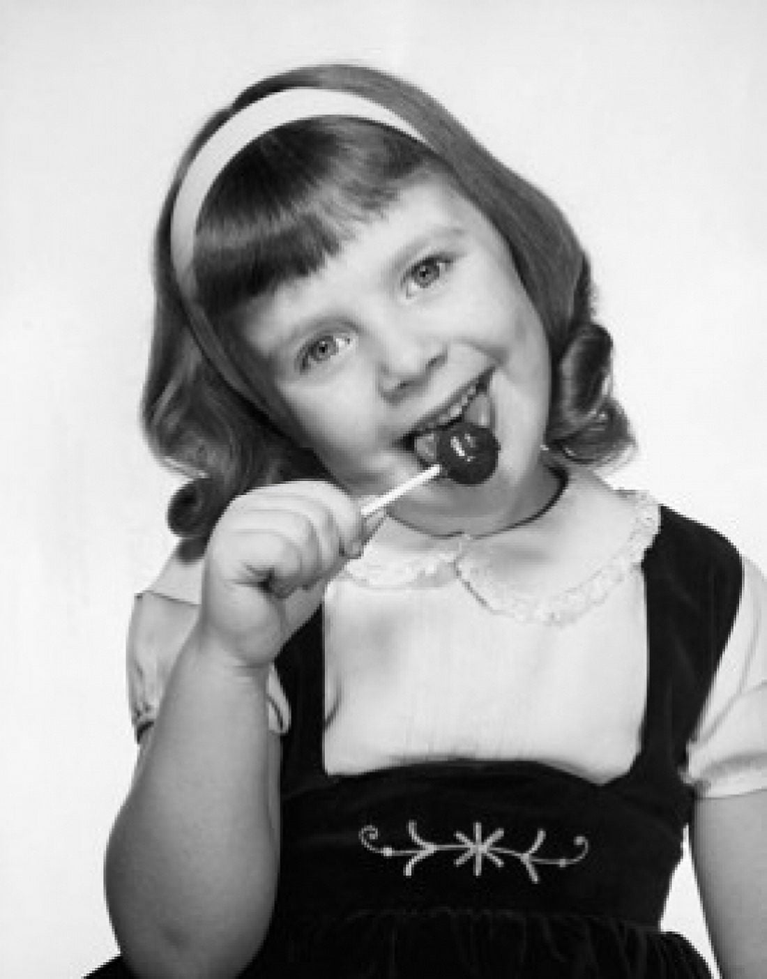 Portrait of a girl licking a lollipop Canvas Art - (24 x 36)