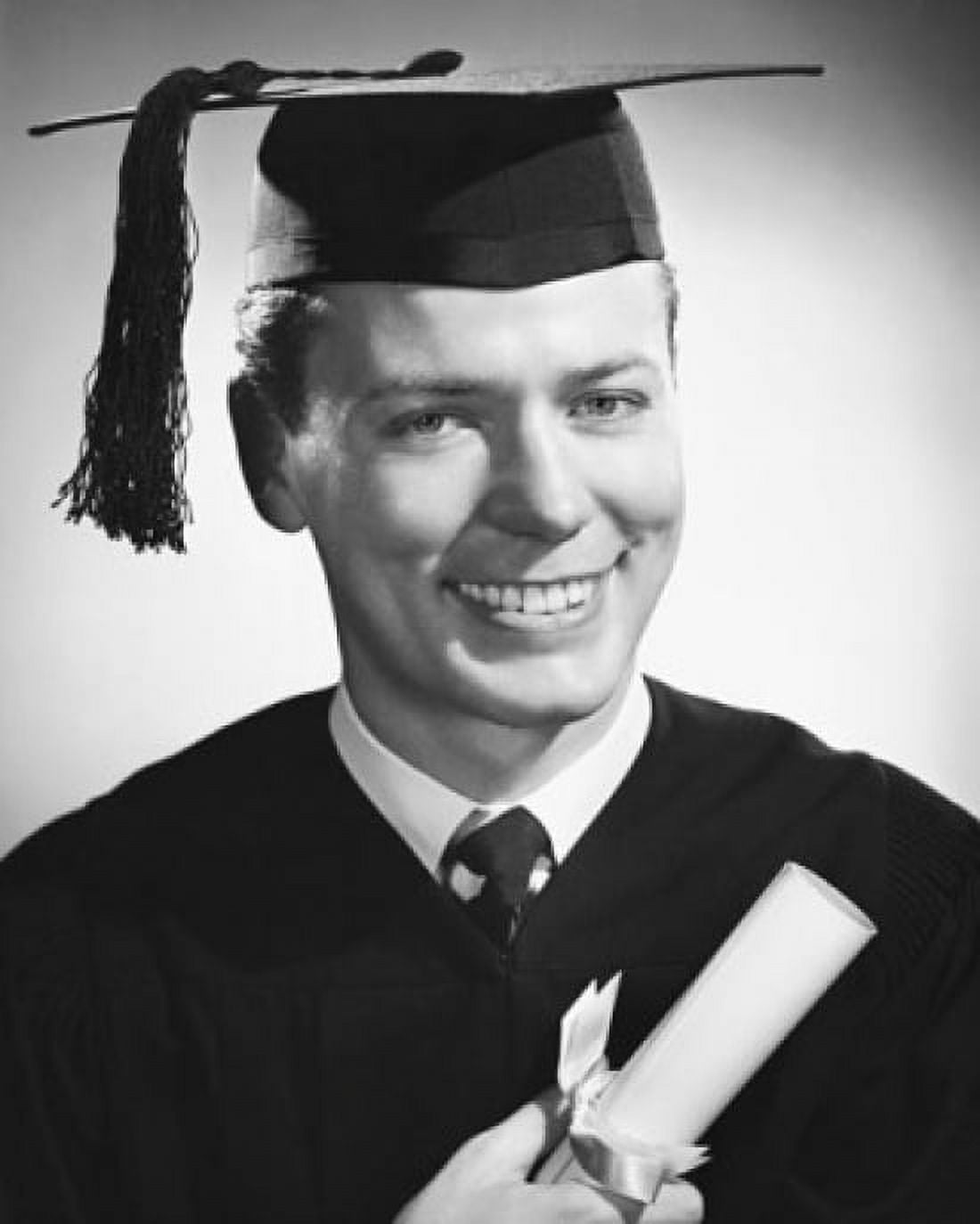 Portrait of a male graduate holding a diploma and smiling Canvas Art - (24 x 36)