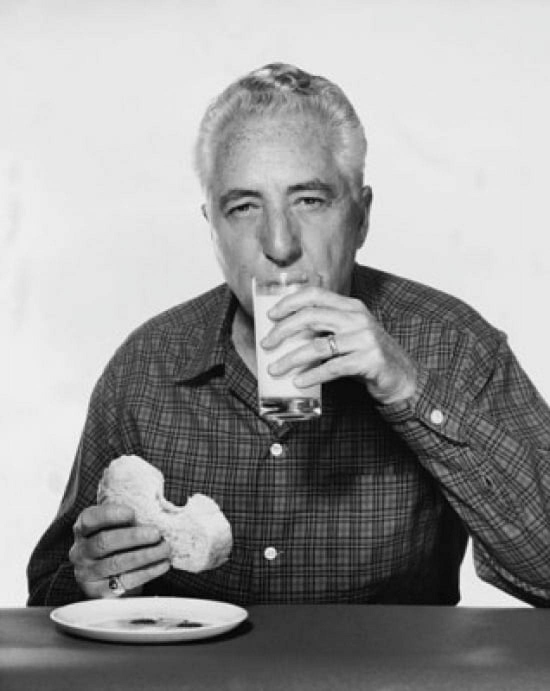 Portrait of a mature man drinking milk and eating bread Canvas Art - (24 x 36)
