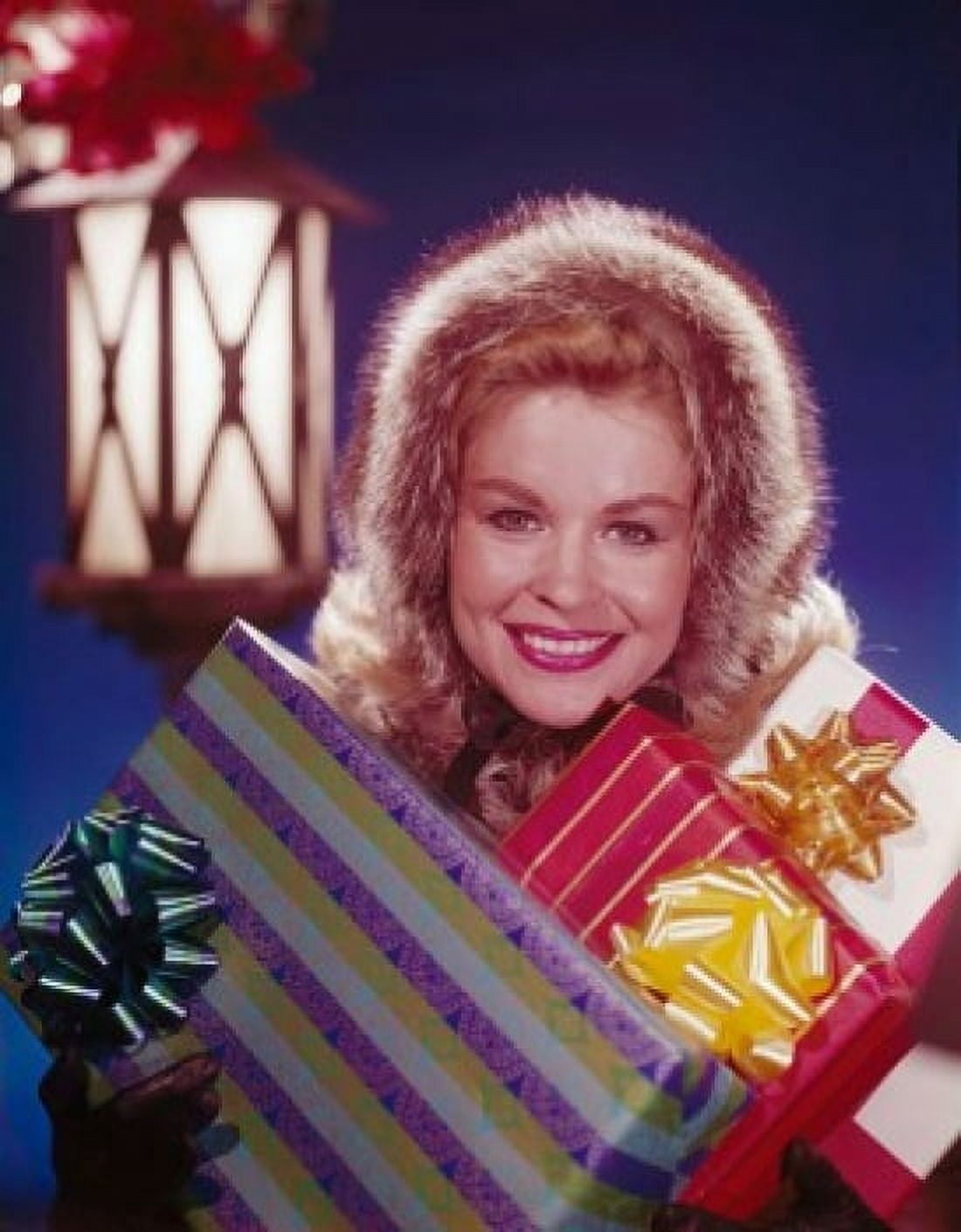 Portrait of a mature woman holding Christmas presents and smiling Canvas Art - (18 x 24)