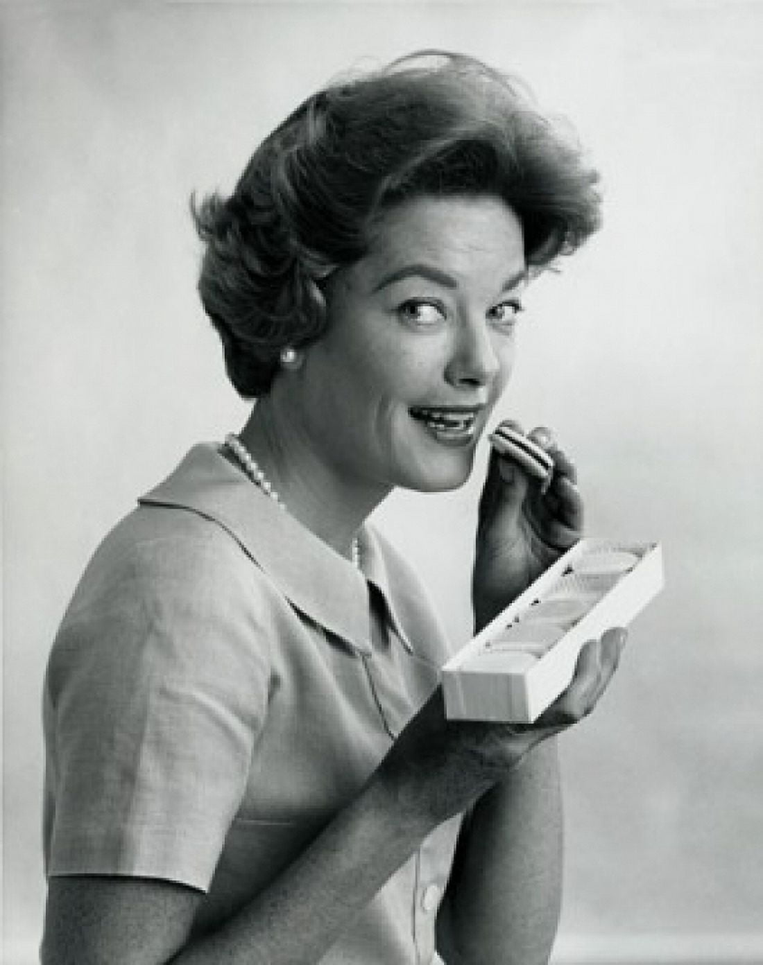 Portrait of a mid adult woman eating biscuits Canvas Art - (24 x 36)