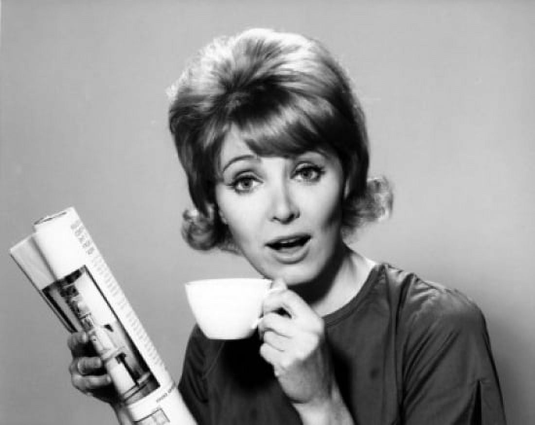 Portrait of a mid adult woman holding a tea cup and a newspaper Canvas Art - (18 x 24)