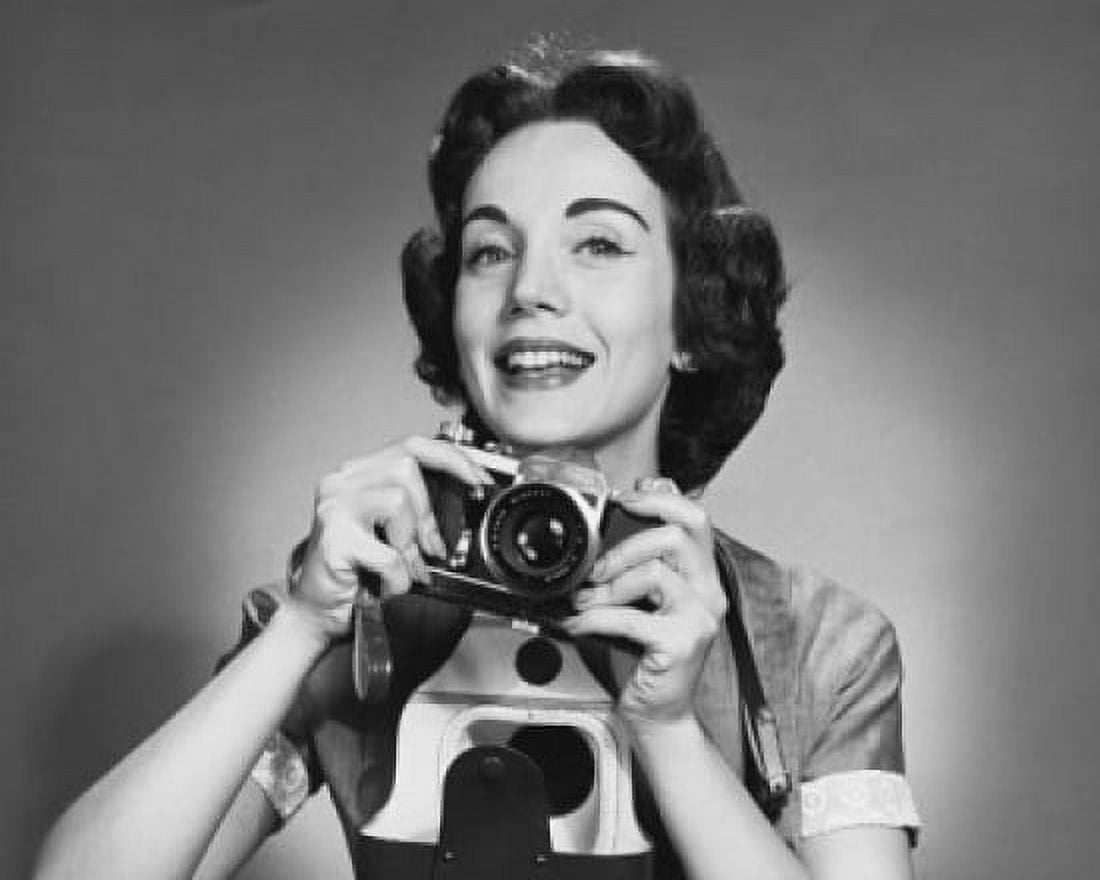 Portrait of a photographer holding a camera and smiling Canvas Art - (24 x 36)