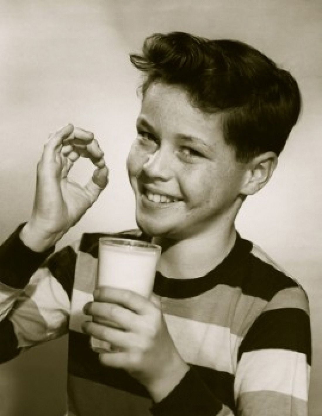 Portrait of a pleased boy holding a glass of milk Canvas Art - (24 x 36)