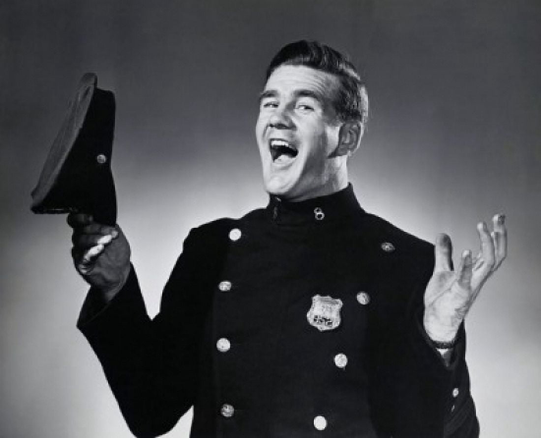 Portrait of a police officer holding a uniform cap and laughing Canvas Art - (24 x 36)