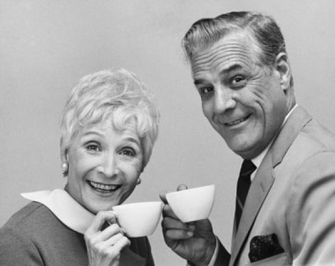 Portrait of a senior couple holding tea cups and smiling Canvas Art - (24 x 36)