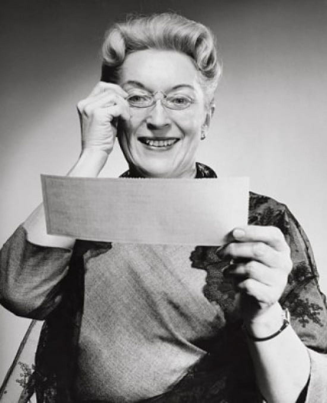 Portrait of a senior woman holding a check and smiling Canvas Art - (18 x 24)
