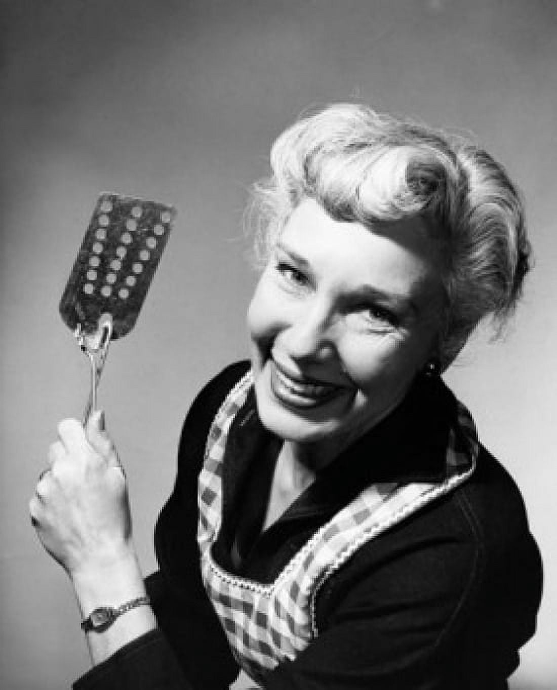 Portrait of a senior woman holding a spatula Canvas Art - (24 x 36)