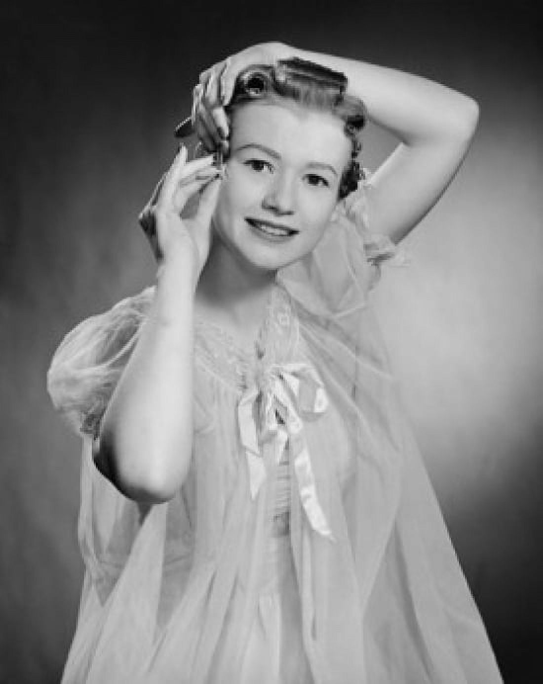 Portrait of a teenage girl using hair curlers Canvas Art - (18 x 24)