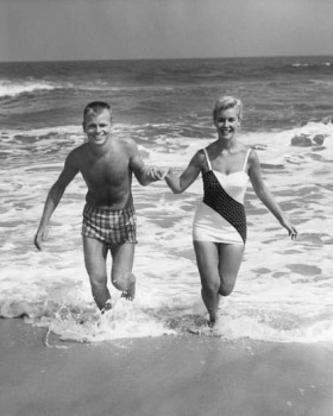 Portrait of a young couple running on the beach Canvas Art - (18 x 24)