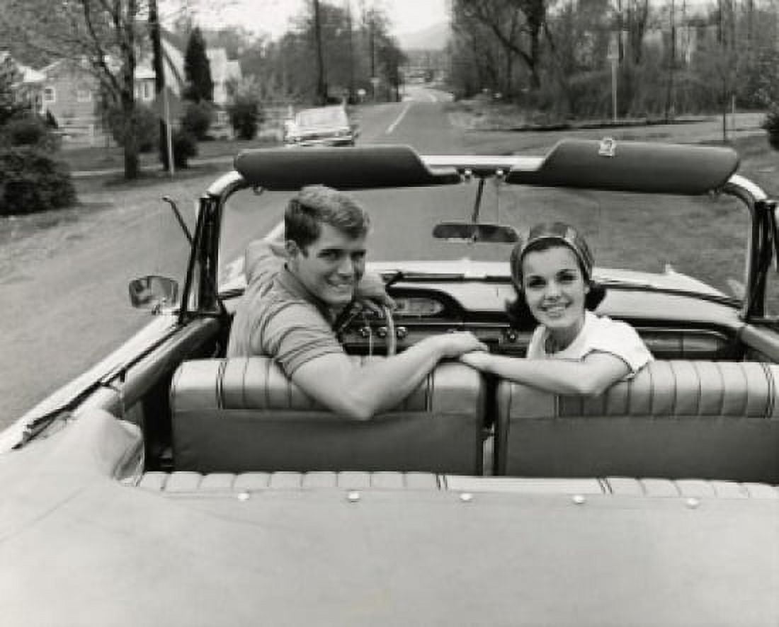 Portrait of a young couple sitting in a convertible car Canvas Art - (24 x 36)