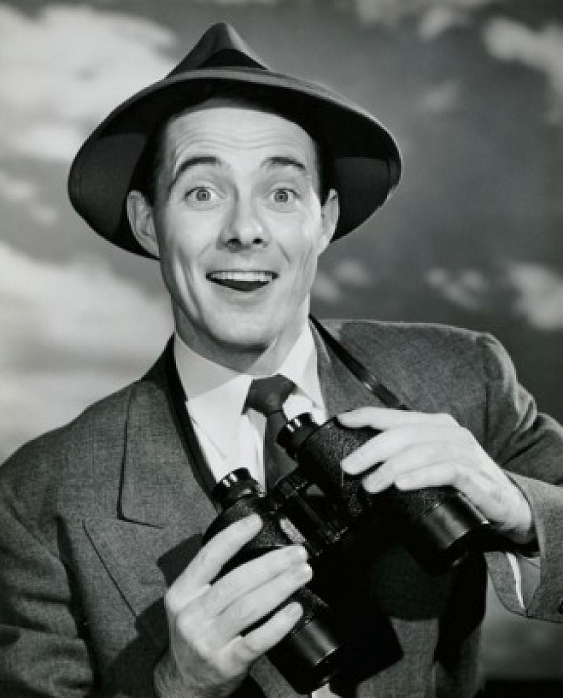 Portrait of a young man smiling and holding binoculars Canvas Art - (18 x 24)