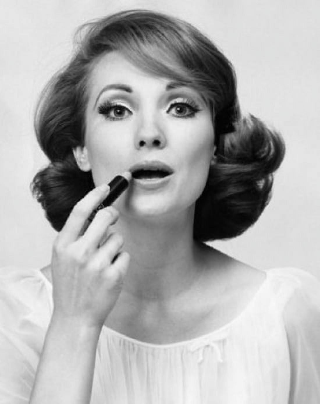 Portrait of a young woman applying lipstick Canvas Art - (24 x 36)