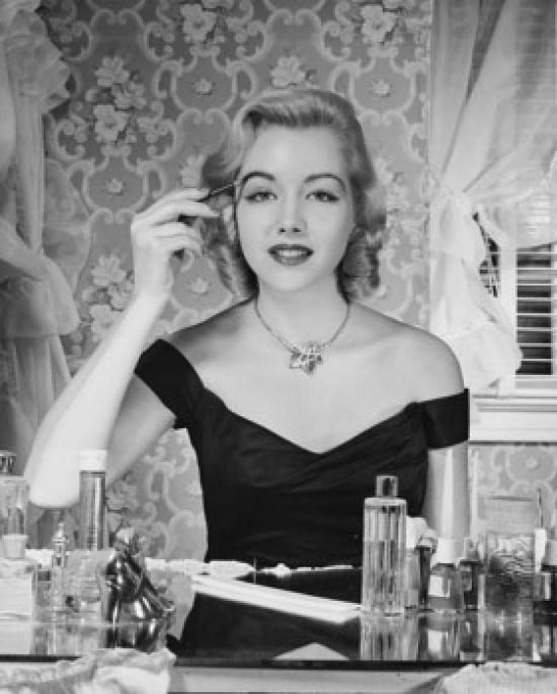 Portrait of a young woman applying make-up Canvas Art - (24 x 36)