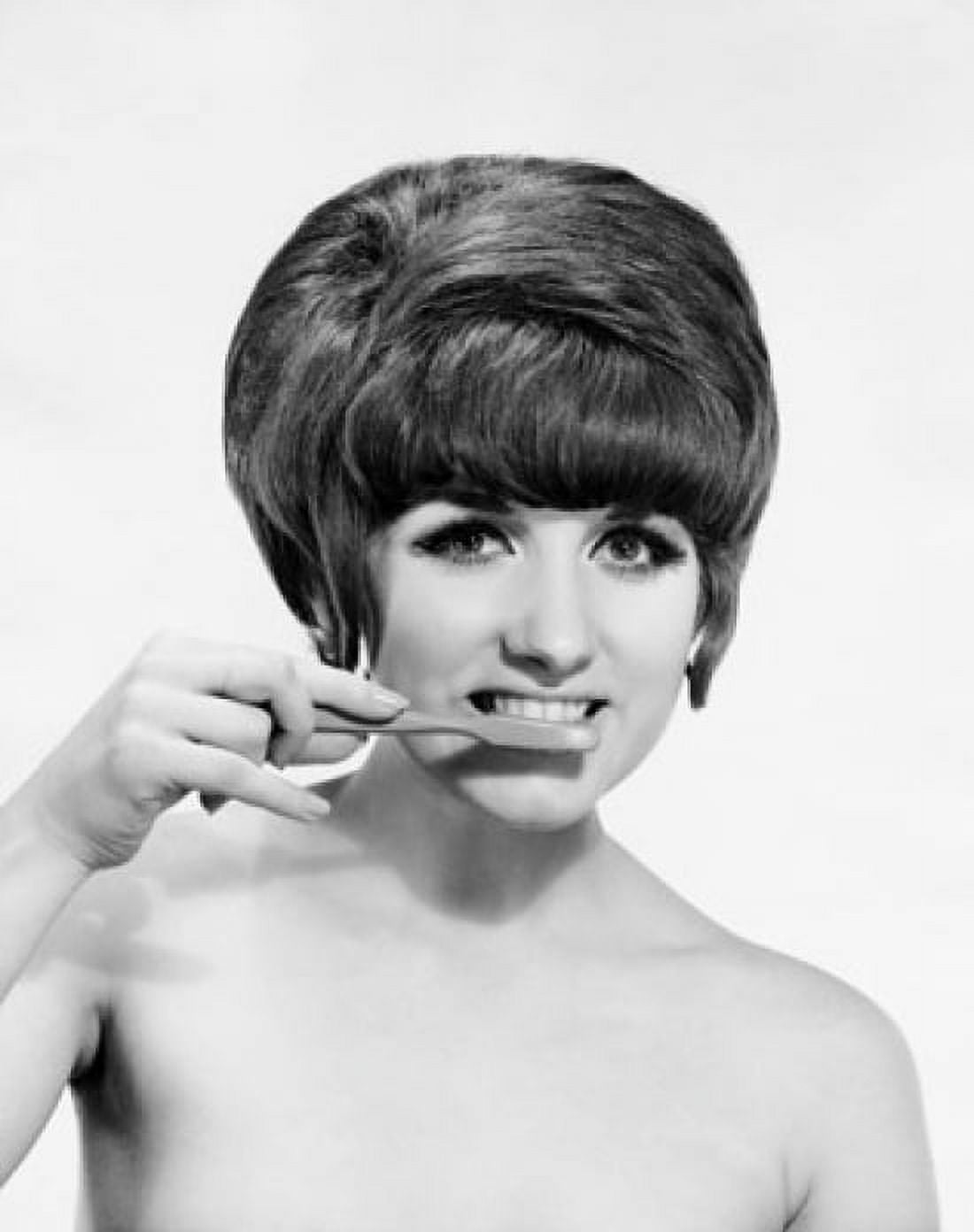 Portrait of a young woman brushing her teeth Canvas Art - (24 x 36)